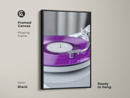 Framed canvas featuring a purple vinyl record. The floating frame is black. The turntable canvas print is ready to hang. A perfect blend of mid-century modern decor. It's great for analog sound art lovers.