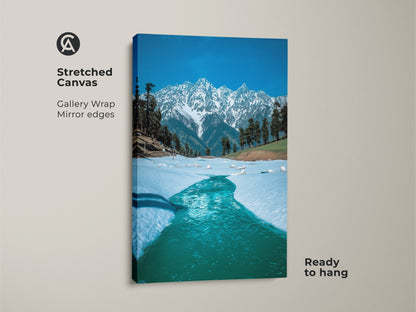 Stretched canvas print of a snowy mountain landscape showcasing gallery-wrapped mirror edges. The blue water and snow-capped peaks offer a realistic touch to any room. Ideal winter landscape wall art that's ready to hang and enhances your home decor.