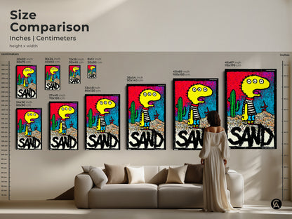 Size comparison of a playful artwork featuring a three-eyed character in a desert setting. See how the art looks in various sizes compared to a sofa and a person. Find the perfect scale for your space. Shop art prints and canvas art online.