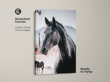 Stretched canvas print of a black horse. This gallery-wrapped artwork features a photorealistic animal against a rustic landscape. Ready to hang this print is ideal for adding wildlife charm to any bedroom or living space. It's a thoughtful equestrian gift.