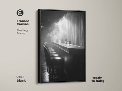 Framed canvas print of a monochrome bar. This floating frame is black and ready to hang. The cinematic scene offers industrial decor. It's a black and white artwork for a lounge. This is perfect for home bar art.