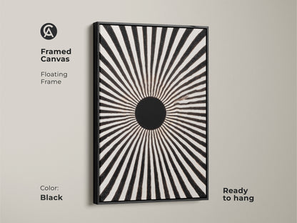 Framed canvas featuring an abstract sunburst design. The floating frame enhances this minimalist black artwork. It is a mid-century modern geometric art piece. The black frame complements the sunburst motif canvas. This ready-to-hang monochrome print adds sophistication to any room. It is impactful wall art for home offices.