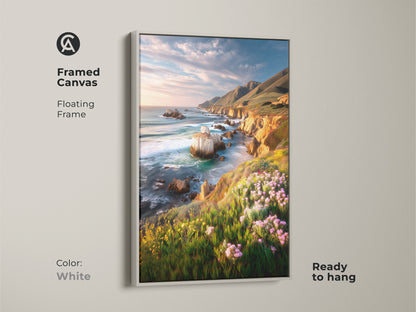 Framed canvas art of a coastal cliff ocean landscape in a white floating frame. Ready to hang this art features vibrant wildflowers and a scenic ocean view. It adds a touch of coastal living to your home decor. Perfect housewarming gift for ocean lovers.