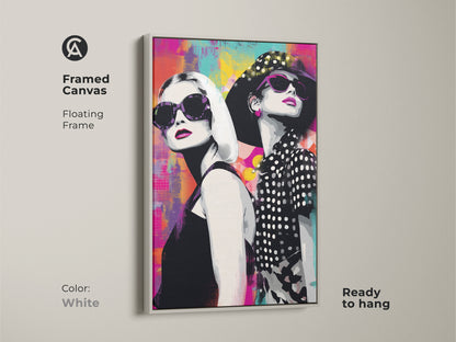 Framed canvas with a white floating frame featuring a pop art style portrait of fashionable women in sunglasses. The vibrant abstract background blends magenta teal and yellow tones. Ready to hang this artwork adds a modern touch to any room. It's a perfect gift for fashion lovers. A chic addition to your home decor.