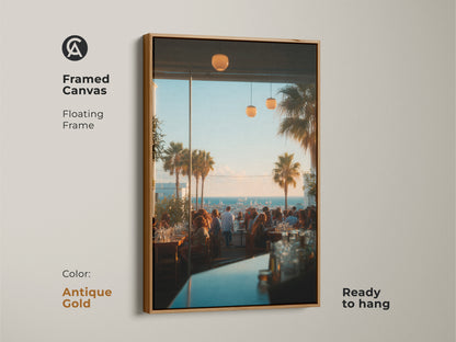 Antique gold framed canvas artwork capturing a bustling restaurant with a coastal view. The floating frame enhances the artwork's luxurious appeal. This ready to hang piece adds a touch of glamour to any room. Perfect for adding a touch of elegance.