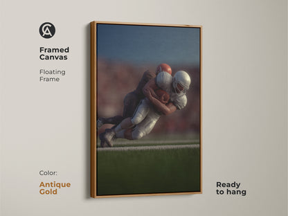 Framed canvas featuring a dynamic football tackle with a floating antique gold frame. Ready to hang this photorealistic sports action wall art is a statement piece. Perfect for a den or man cave this football artwork makes a great gift for any sports fan. Celebrate team sports with this intense moment.