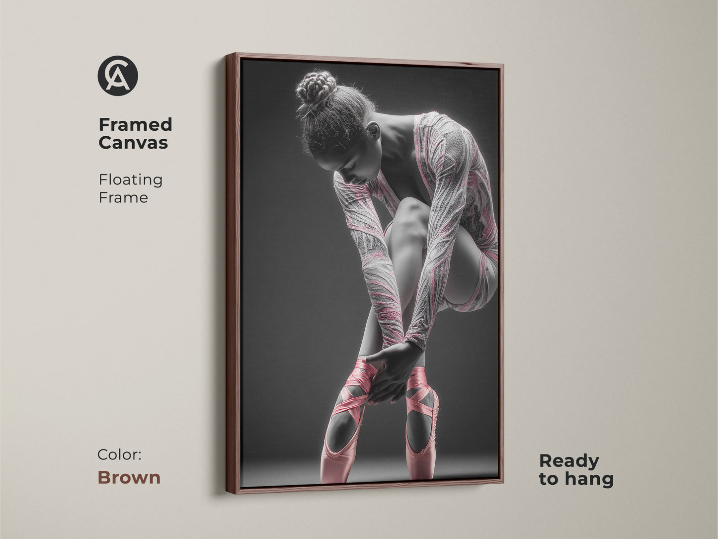 Framed canvas artwork featuring a ballerina. This canvas has a floating frame. The frame color is brown. The art features a ballerina tying her pink ballet shoes. This framed art is ready to hang.
