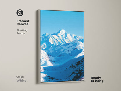 A framed canvas features a floating frame in white showcasing a snowy mountain landscape. This ready-to-hang nature artwork brings serene alpine scenery indoors. The blue sky mountain art is perfect for minimalist home decor styles. It makes a thoughtful gift for outdoor enthusiasts and hikers.