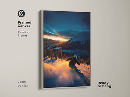 A framed canvas art piece features a skier set against a mountain sunset. The clean white floating frame offers a modern and minimalist aesthetic. Ready to hang this piece will brighten any room. Ideal for contemporary art lovers seeking framed canvas art.