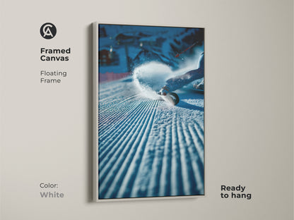 Framed canvas art featuring a snowboarder carving through snow. The floating frame is white. It offers a clean and contemporary look. This artwork is ready to hang. It is perfect for brightening up any room. Get yours today.