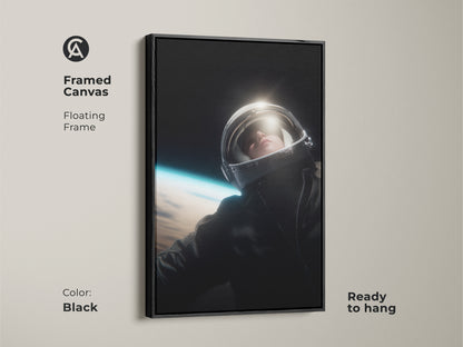 Elevate your decor with this framed astronaut canvas. The black floating frame enhances the black and white tones of the artwork. It features a striking view of Earth. The art comes ready to hang. Ideal for adding a touch of cosmic inspiration to your office or home.