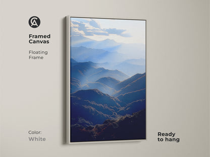 Framed canvas featuring a deep blue mountain range. This atmospheric landscape wall art comes with a floating white frame. This serene valley artwork is ready to hang. The modern art piece enhances any contemporary decor. A perfect gift for outdoor enthusiasts.