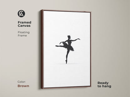 Framed in a brown floating frame this canvas presents minimalist black ballerina art. The artwork adds elegance to any room. This contemporary piece is perfect for modern home decor. It is a great gift for dancers and those who appreciate fine art and artistic ballet artwork.