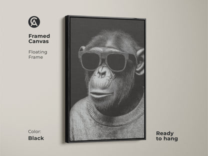 Framed canvas showcasing a chimpanzee wearing sunglasses. The floating frame is black and ready to hang. This minimalist art is a monochrome animal portrait. It is stylish chimpanzee art for a modern office. The contemporary animal art adds personality to any space.