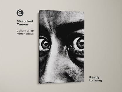 Stretched canvas print of an intense black and white face portrait. This monochrome eyes wall art features gallery wrap mirror edges. Ready to hang this contemporary portrait print brings expressive eyes artwork to your living room. Modern monochrome decor for dramatic home ambiance.