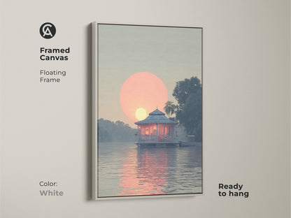 Framed Canvas coastal lake house art with floating frame and white color. The art features a peach and blue tropical landscape and a serene waterfront bungalow painting. This boating sunset view artwork is ready to hang.