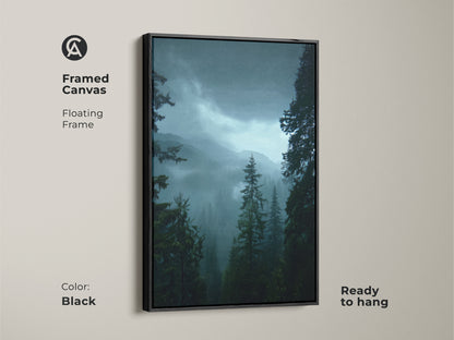 Framed canvas print of a misty mountain range wall decor in black. This deep green nature artwork is ready to hang. The pine tree forest art adds a rustic touch to any room. Perfect for creating a serene and ambient atmosphere.