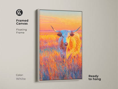 Framed canvas artwork featuring a longhorn in a field. The floating frame is white. This ready-to-hang piece adds a touch of western elegance. The artwork's vibrant colors brighten up any space. It is perfect for art collectors.