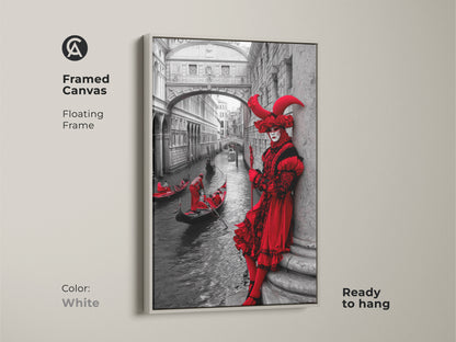 Explore this Venice Carnival art print. A crimson red masked figure & gondola against a black & white architectural scene. This framed canvas with a white floating frame. It is an eclectic addition to your home decor. A perfect travel souvenir or a Carnival Season gift.
