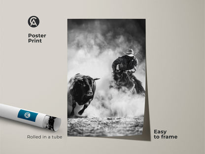 This poster print features cowboy rodeo wall art. It shows a Western action scene. The print is monochrome cowboy decor. This grayscale bull art will look great in a man cave. It is an easy to frame print rolled in a tube.