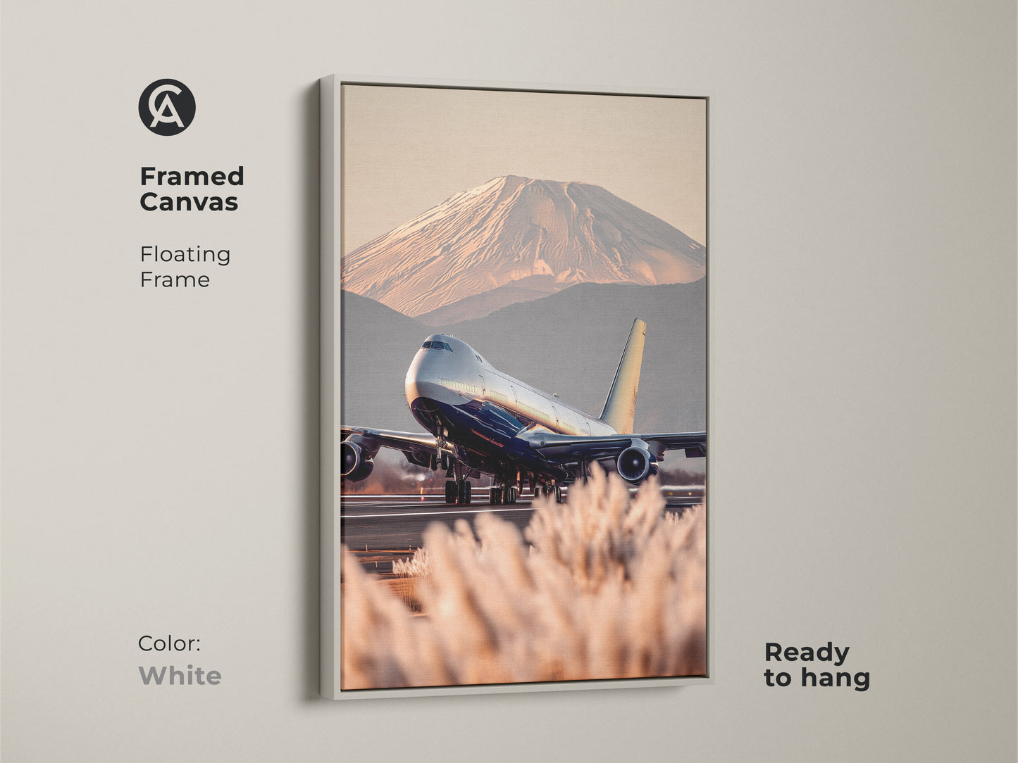 Framed canvas art featuring an airplane taking off with Mount Fuji in the background. The floating frame is white. Contemporary travel photography canvas in blue gold and beige tones. This aviation art is ready to hang. Perfect for entryway or office decor. A great housewarming gift idea.