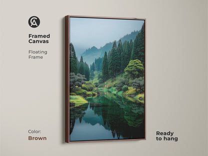 Framed canvas art with a floating frame in brown. The artwork features a reflective lake surrounded by green trees. This ready to hang piece adds warmth to any room. Shop today.