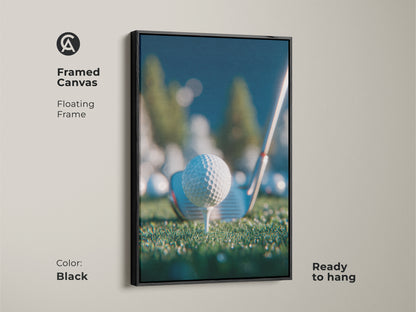 Framed canvas artwork in a black floating frame shows a golf ball on a tee. It comes ready to hang. The print is perfect for golf enthusiasts. Add a touch of sporty elegance to your space. Shop framed art now.
