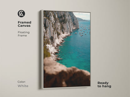 Framed Canvas in White of Deep Blue Ocean Canvas. A turquoise yacht art print creates a fresh and airy feel. The floating frame enhances the coastal cliff wall art making it a serene addition to any room. Ready to hang and enjoy.