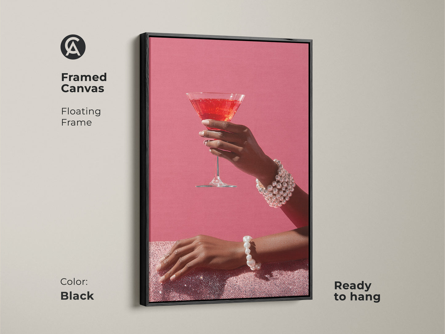 Enhance your walls with this framed canvas of chic pink martini art. The black floating frame adds a touch of elegance. The artwork features a hand with a pearl bracelet. This contemporary cocktail decor is ready to hang. Perfect glam bar wall art.