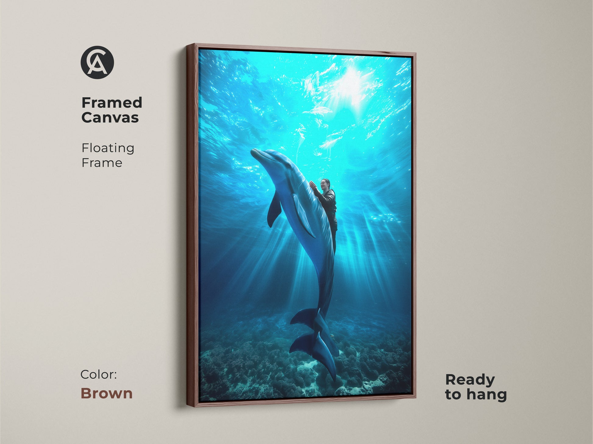 A framed canvas shows a person riding a dolphin. It's a deep blue underwater scene. The coastal home decor print is ready to hang. Its brown floating frame enhances the aquatic artwork. It is a unique ocean art piece.