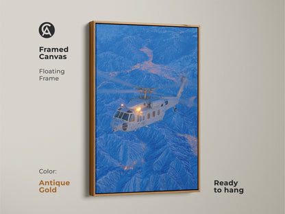 This framed canvas features a helicopter flying over a mountainous landscape. The antique gold floating frame adds a touch of vintage charm. This aviation artwork is ready to hang and will be a conversation starter in any room.