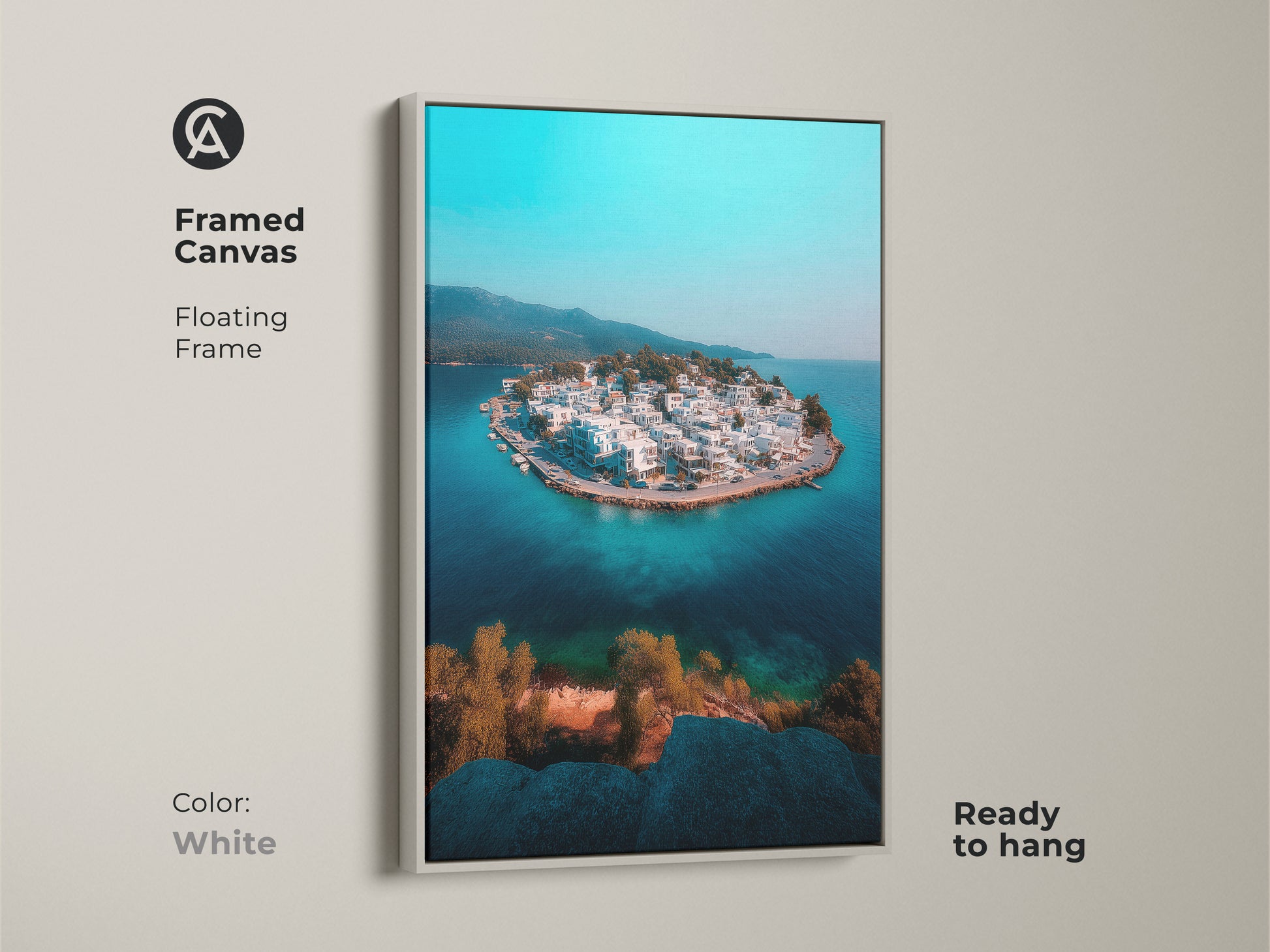 This framed canvas with a white floating frame features a breathtaking aerial view of a coastal island. The turquoise ocean and white buildings bring a serene and modern vibe. Ready to hang this artwork is ideal for coastal or travel-themed decor offering a tranquil island getaway art print.