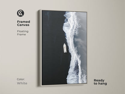 White framed canvas of minimalist ocean artwork. A floating frame accents the aerial boat view. Ready to hang coastal beach decor for a modern seascape print.