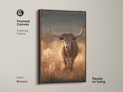 Framed canvas art of a longhorn bull in a savanna. This rustic western wildlife art features earthy tones and a brown floating frame. The warm brown art print is ready to hang. It will add character to any room. This is perfect as rustic wall art.