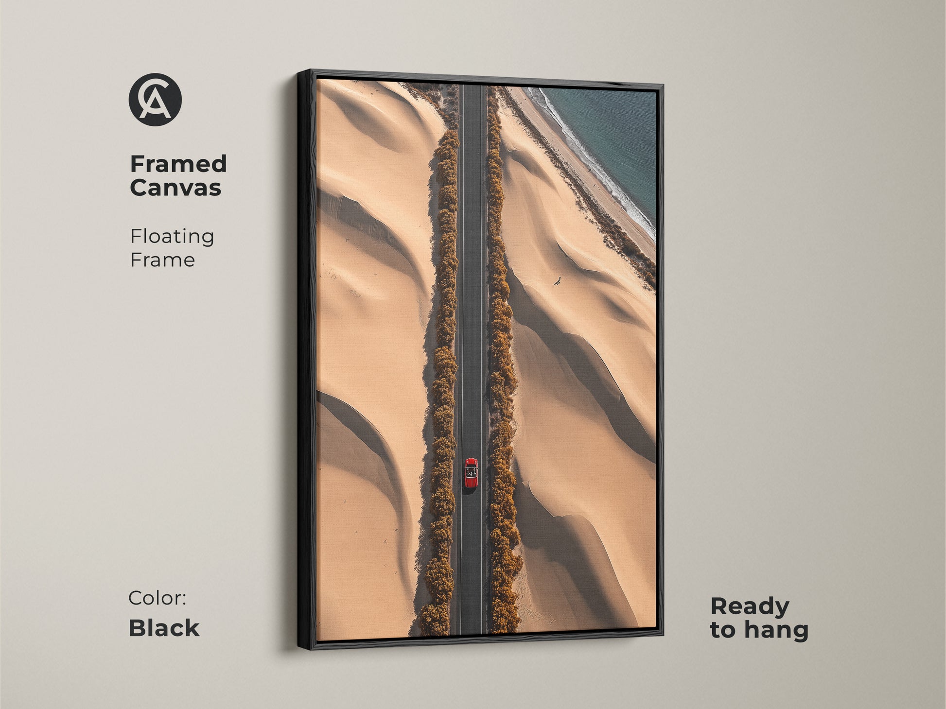 Framed in black this desert road art print features a red car on a sandy beige road. The floating frame enhances this contemporary travel landscape. Ready to hang this artwork brings an ocean view to your home or office decor. It is a unique piece of modern desert art perfect as a gift.