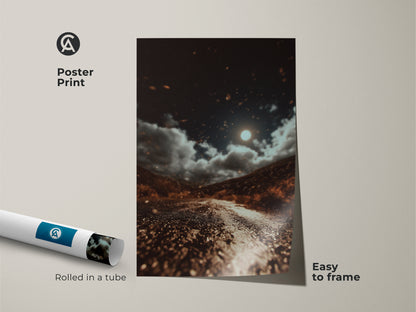 This poster print showcases a moonlit road. The dark brown landscape artwork has gray and orange accents. It's an eclectic home decor piece for adventure lovers. The nature wall art print is easy to frame. The celestial night sky canvas captures a cinematic road trip. This moody landscape artwork adds beauty to any space.