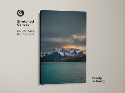 Stretched canvas gallery wrap featuring a teal lake and snowy mountain range. This contemporary nature wall art is ready to hang. A cool toned landscape art for modern home decor.