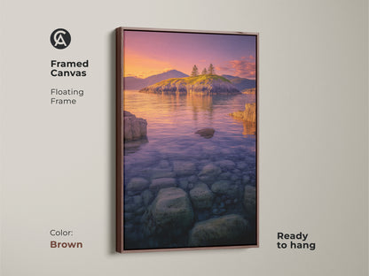 Framed Canvas Island Seascape with a brown floating frame. The Coastal Sunset Wall Art captures the natural beauty of an island. Ocean landscape photography shows clear water and stones. The purple orange sky artwork is ready to hang.