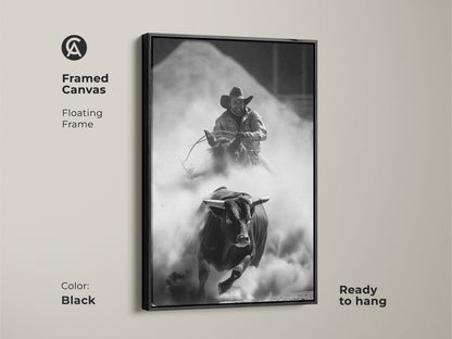 Framed Canvas of a Monochrome Rodeo scene in a black floating frame. This Western wall art features a bull rider and charging bull. The rustic cowboy decor is ready to hang. Perfect for a man cave or office. This adrenaline art print captures the spirit of the rodeo.