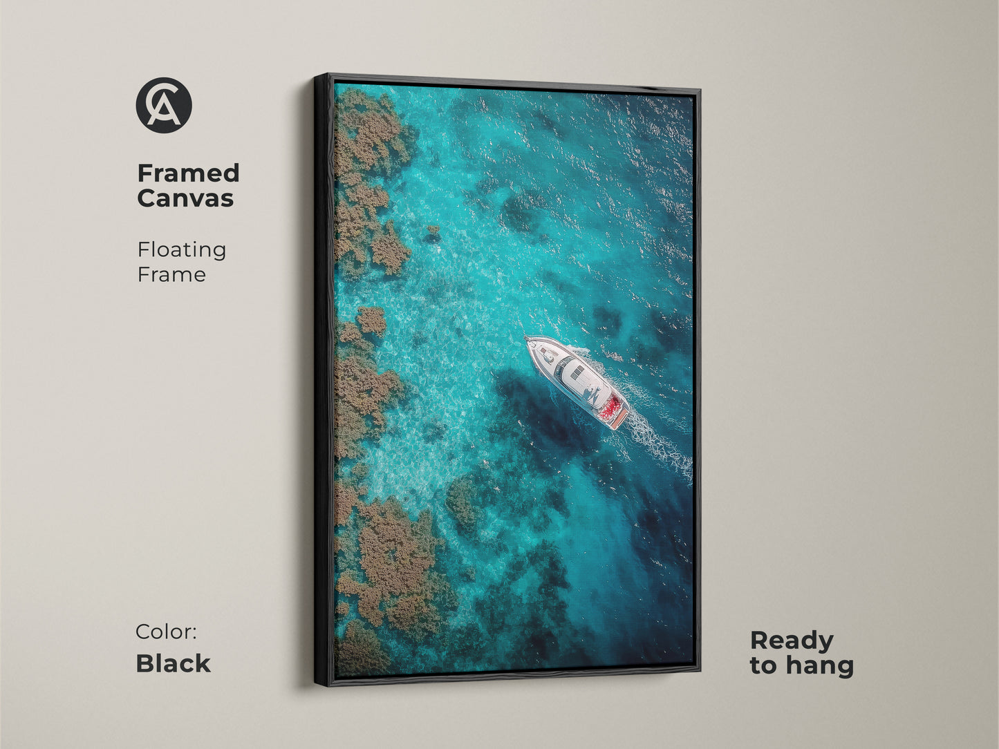 Black framed canvas showcases a boat sailing on clear turquoise waters. This floating frame art piece is ready to hang. The aerial view of the ocean and coral reefs adds a modern touch.