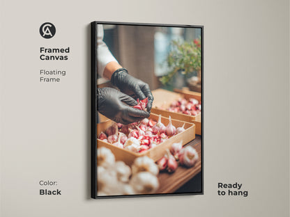 Framed canvas art showing a chef preparing garlic. The frame is a floating black frame. The artwork is ready to hang. This piece adds a culinary touch to any kitchen or restaurant. Great art for kitchen decor.