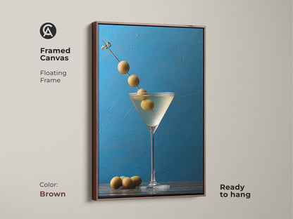 Framed canvas with a brown floating frame displaying martini glass artwork. This modern kitchen decor is ready to hang. The contemporary bar art features an olive garnish. Azure blue background enhances this still life artwork. A unique contemporary gift for sophisticated wall art.