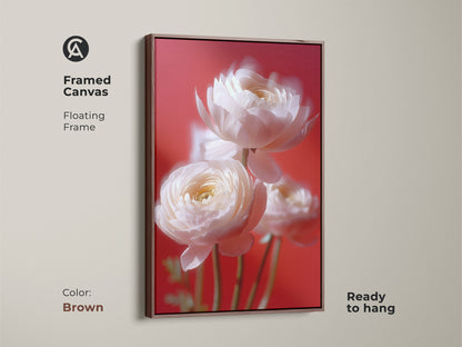 Brown framed canvas featuring a soft focus flower print of white ranunculus against a coral pink backdrop. A botanical photography wall art adding a touch of nature to your space. This elegant floral wall decor is a perfect wedding anniversary gift. Elevate your contemporary home with this artwork.