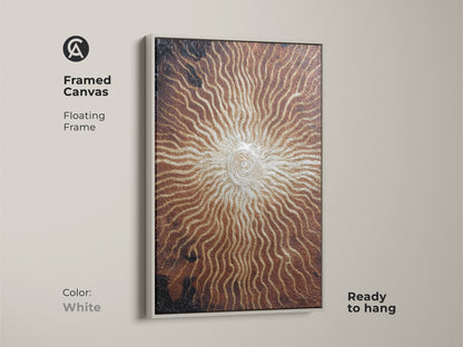 White framed canvas featuring bronze gold spiral artwork. This abstract sunburst print is ready to hang. The textured eclectic artwork is a modern metallic piece. A thoughtful housewarming gift for art enthusiasts.