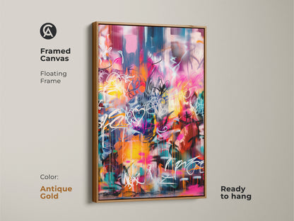Framed canvas of graffiti-style artwork in an antique gold floating frame ready to hang. The contemporary art piece features pink yellow and blue tones. The antique gold frame adds a touch of elegance to the artwork. Perfect for a sophisticated touch.