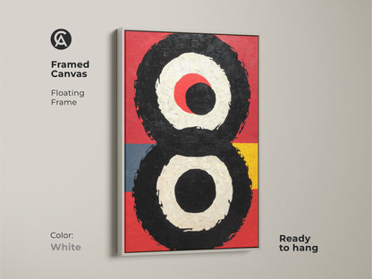 Framed canvas in white floating frame showing a contemporary piece of abstract expressionism art. Red black and geometric circle print create a striking visual. Art lover gift idea perfect for housewarming.