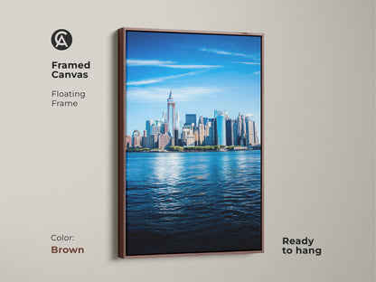 Framed canvas of the NYC skyline art with a floating brown frame. This ready to hang cityscape is modern home office art. It features a contemporary urban decor with azure skyline.