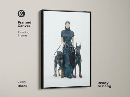 Framed canvas featuring a woman with Dobermans in a floating black frame. Ready to hang. Monochrome minimalist art for a modern touch. Perfect for dog lovers. High-contrast black and white artwork. Contemporary wall decor.