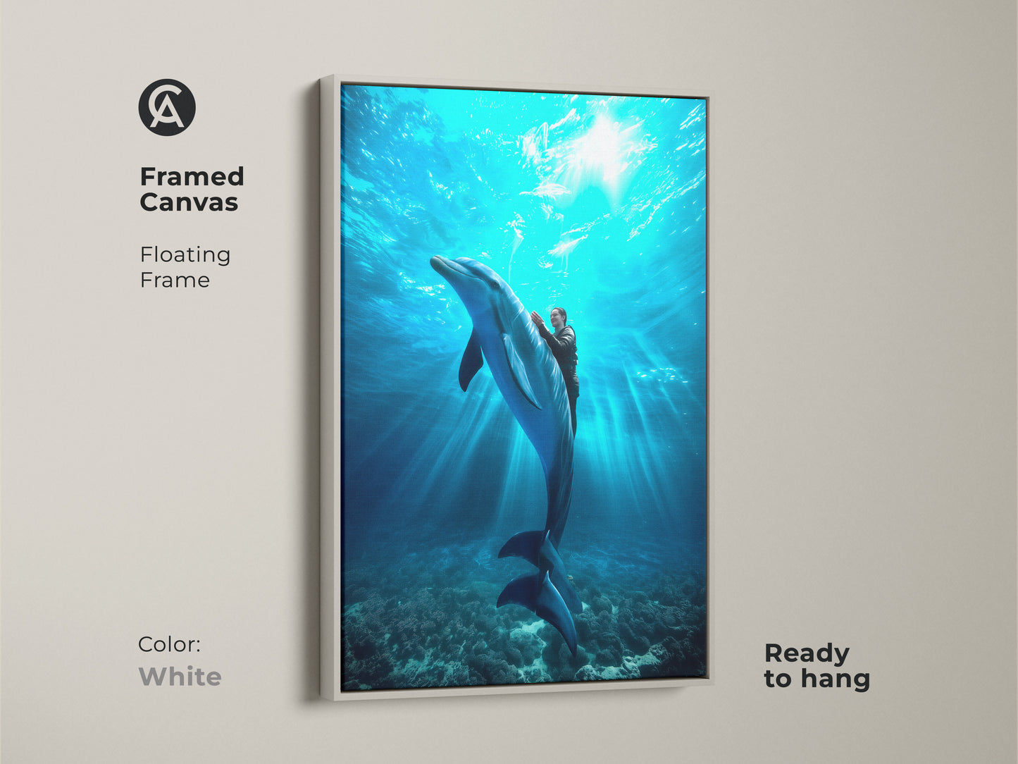A framed canvas shows a person riding a dolphin. It's a deep blue underwater scene. The coastal home decor print is ready to hang. Its white floating frame enhances the aquatic artwork. It is a unique ocean art piece.