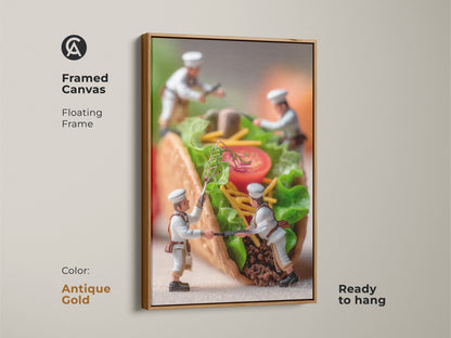 Framed canvas artwork showcasing miniature chefs assembling a taco in a antique gold floating frame. This ready to hang piece brings culinary art to your walls. It's a modern twist on traditional art. Explore framed art today.